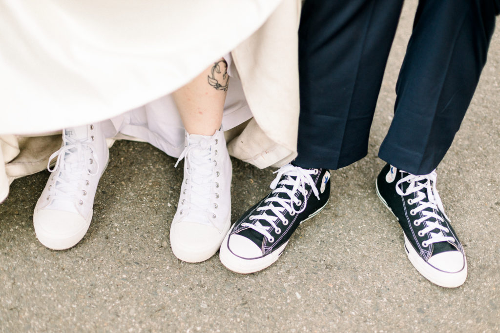 couple showing off converse shoes on wedding day in spokane valley wa 